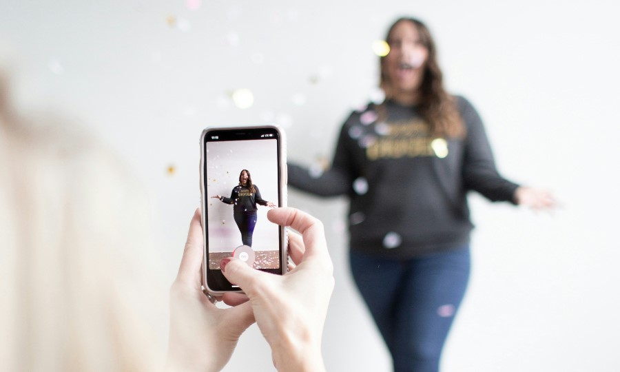 Woman recording a TikTok video